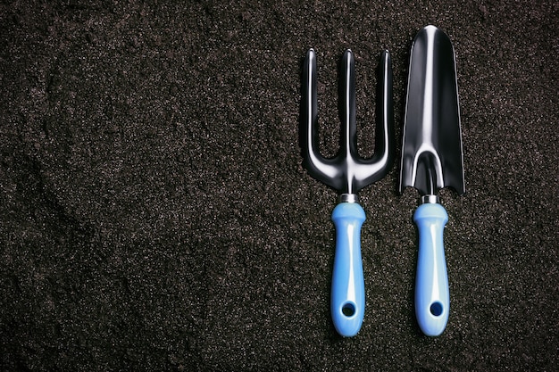 Gardening tools on a background on the ground