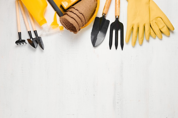 Gardening tools and equipment on white wooden table