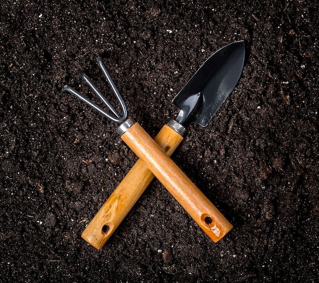 Gardening tools on plain soil