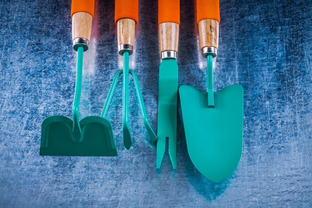 Gardening tools on scratched metallic background agriculture concept