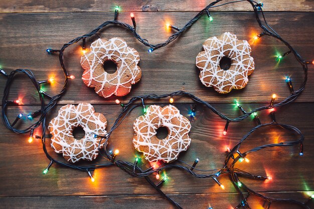 Garland and christmas cookies on the wooden table