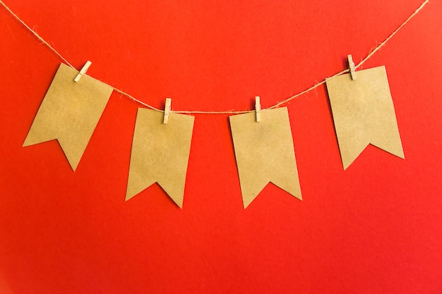 Garland of craft flags on clothespins on a red background