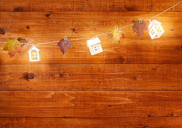 garland in the form of houses on a wooden wall