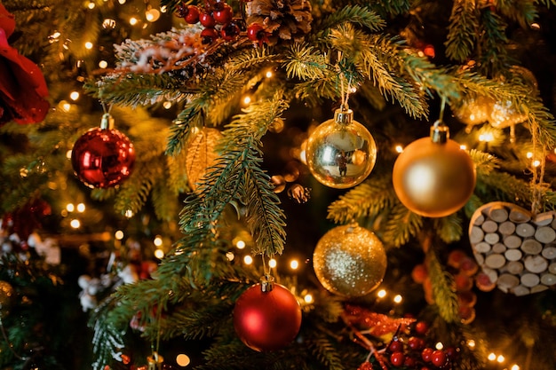 The garland glows brightly synopsis of the new year and holiday\
golden balls on a tree