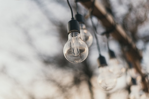 Garland of light bulbs on a wooden pedestal