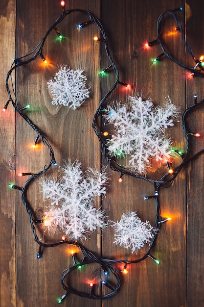 Garland and snowflakes on the wooden table