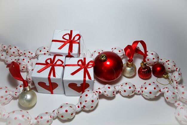 Garland of white balls in a red dot white gift boxes white and red balls on a white background