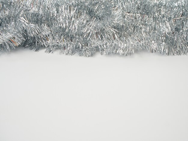 Photo garlands of silver tinsel on white background