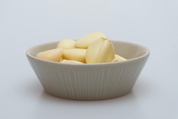 Garlic in a bowl on a white background