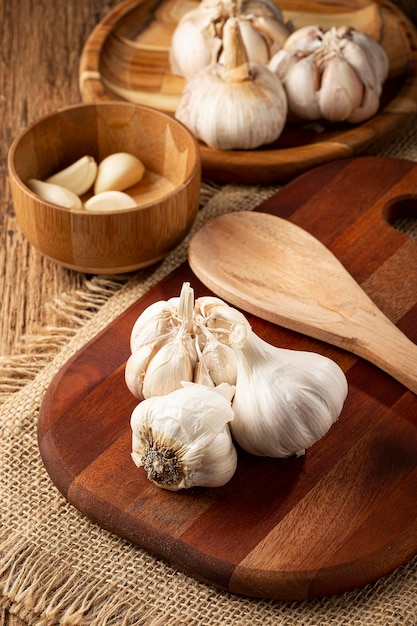 Garlic bulb and garlic cloves on the wooden table