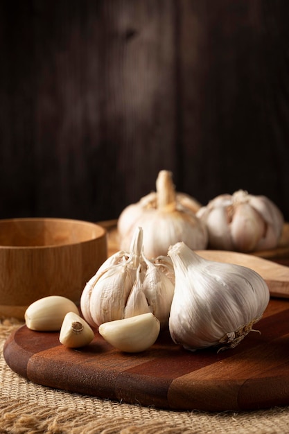 Garlic bulb and garlic cloves on the wooden table