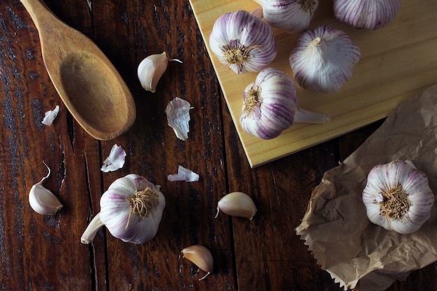 Garlic bulbs spread on rustic wooden table