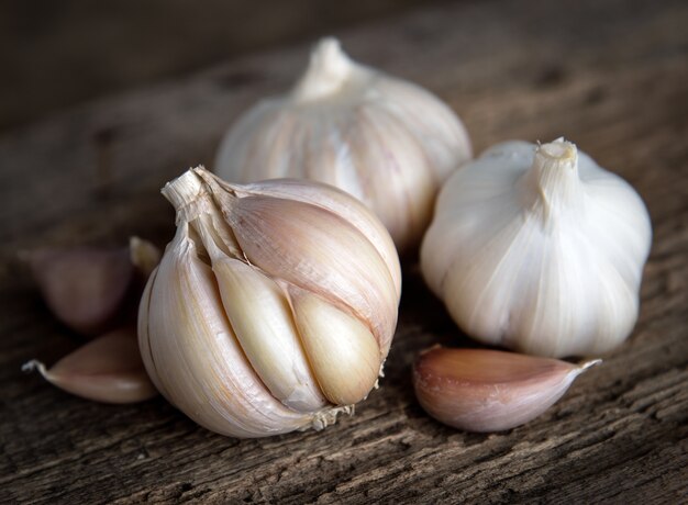 Garlic bulbs with garlic cloves on wooden.