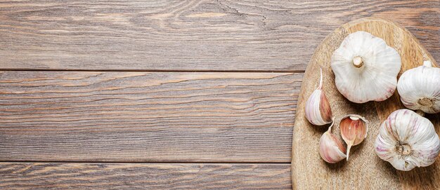 Garlic bulbs on a wooden chopping board Copy space