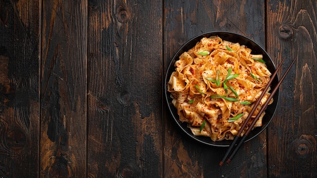 Photo garlic chili oil noodles on old wooden background top view copy space