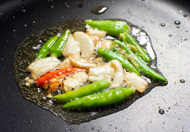 Garlic and chilli fry on a vegetable oil in a black hot pan