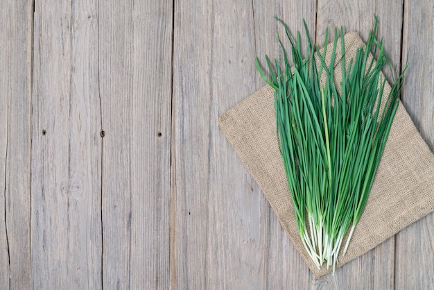 garlic chive on wood backgroundtop view