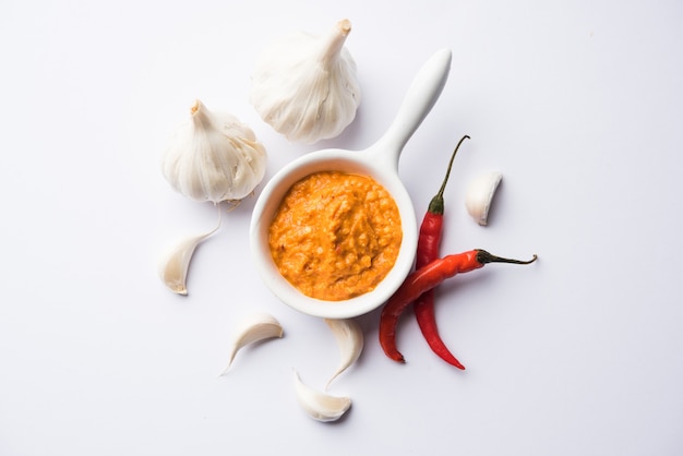 Garlic chutney, made using lahsun or lehsun originating from the India, served in a bowl over moody background. selective focus