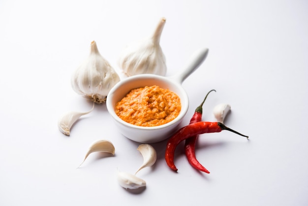 Garlic chutney, made using lahsun or lehsun originating from the India, served in a bowl over moody background. selective focus