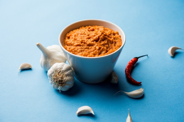 Garlic chutney, made using lahsun or lehsun originating from the India, served in a bowl over moody background. selective focus