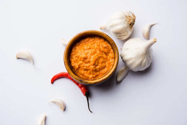 Garlic chutney, made using lahsun or lehsun originating from the India, served in a bowl over moody background. selective focus