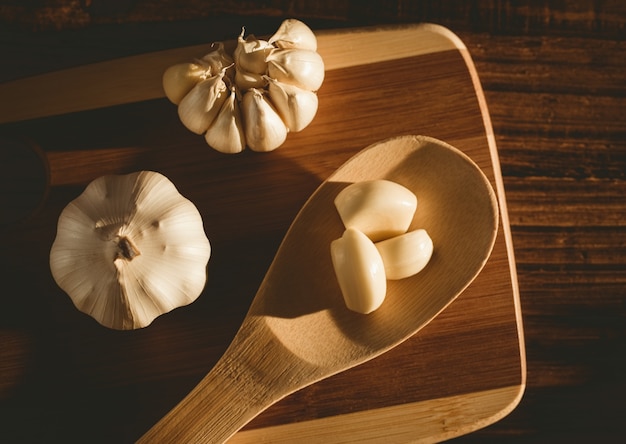 Garlic cloves and bulb on chopping board