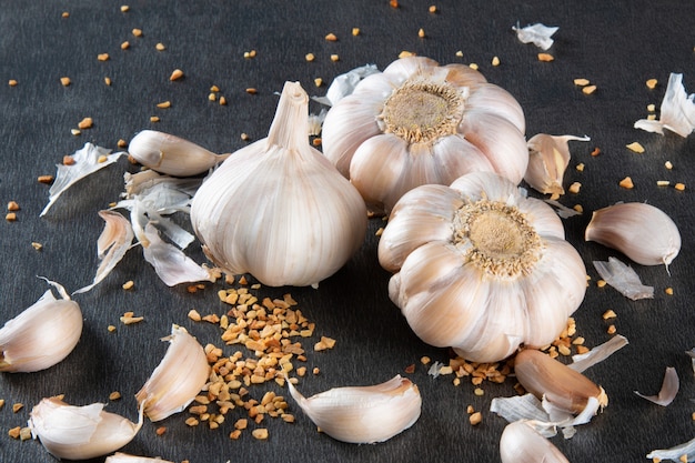 Garlic Cloves and Bulb on Dark Background.