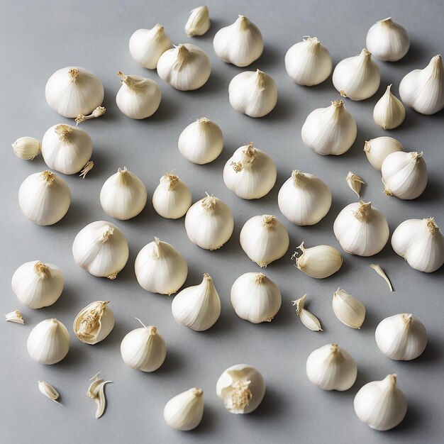 Photo garlic cloves and bulb flying on a white background