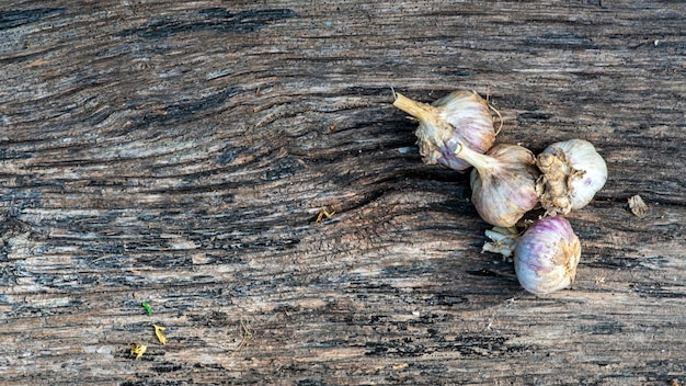 Garlic cloves pile closeup Garlic clove group on wood rustic table background side view