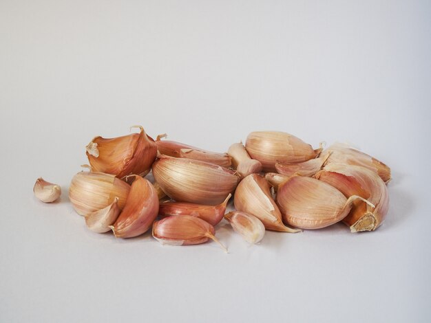 Garlic cloves on a white background.