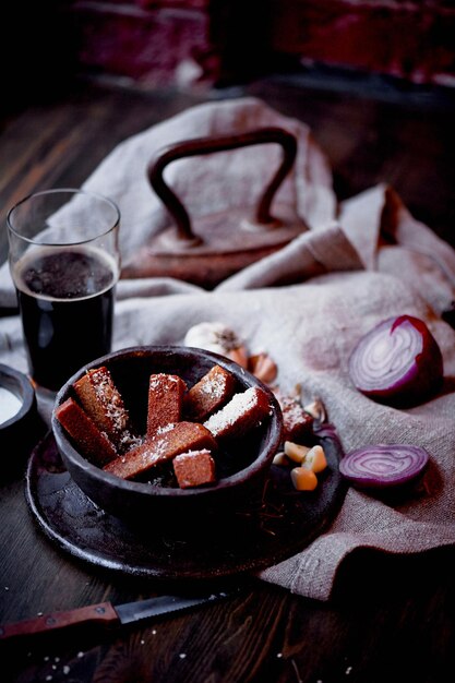 Garlic croutons in the dark interior of the pub Hearty quick lunchAtmospheric photo Dark beer