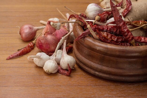 Garlic and dried chillies on table.