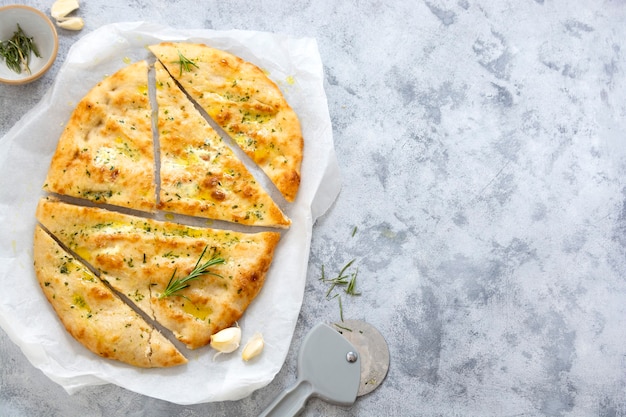 Garlic foccacia bread. Freshly baked flat garlic bread with olive oil and herbs.Copy space.