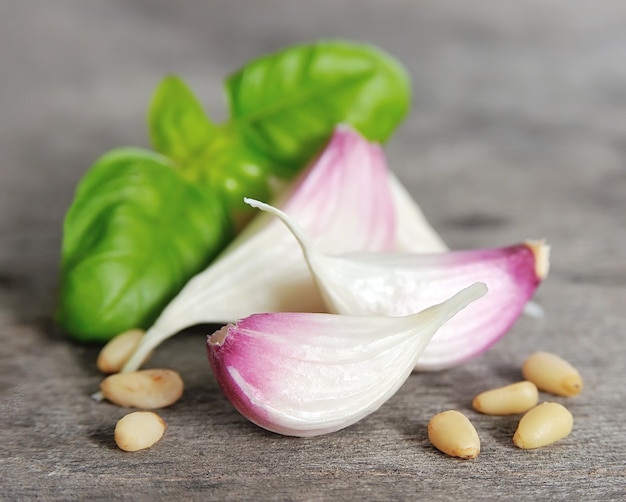 Garlic and fresh basil close up on wooden tables