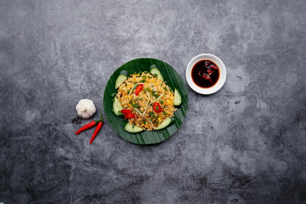 Garlic Fried Rice with fish sauce and salad salad served in dish isolated on dark grey background top view of japanese food