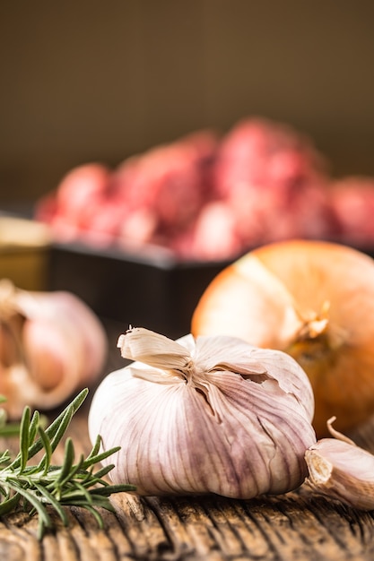 Garlic. Garlic onion rosemary and raw beef meat in the background.