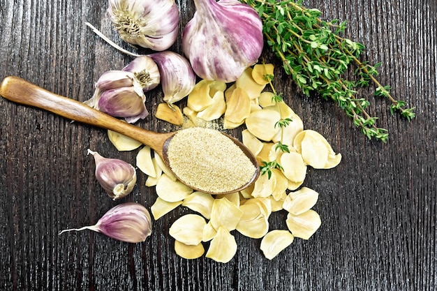 Garlic ground in spoon on dark board top