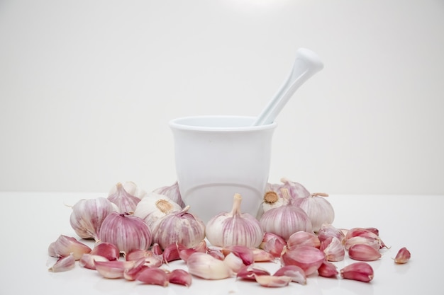 garlic head on the table with spice grinder