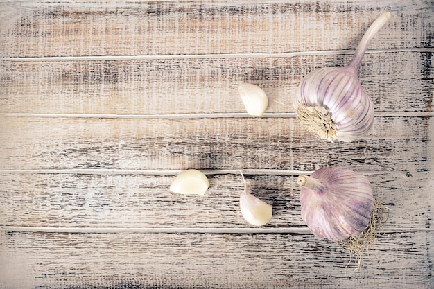 garlic heads on a dark stone - top view