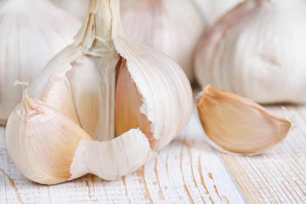 Garlic on old wooden cracked surface Closeup