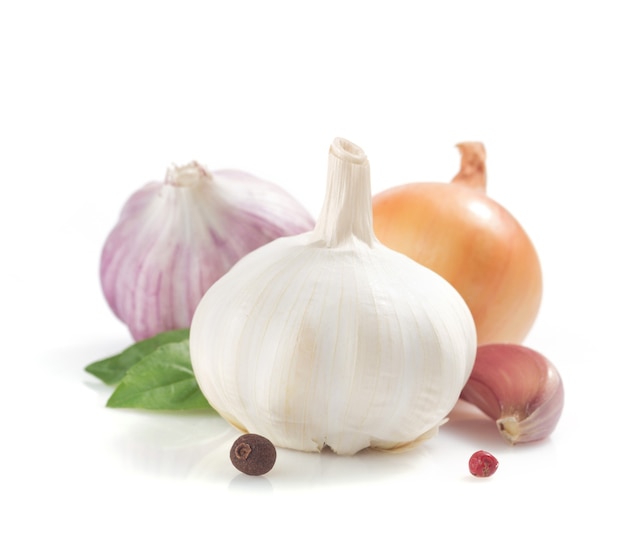 Garlic, onion and spices isolated on white