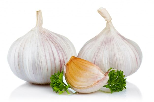 Garlic and parsley leaves isolated on white