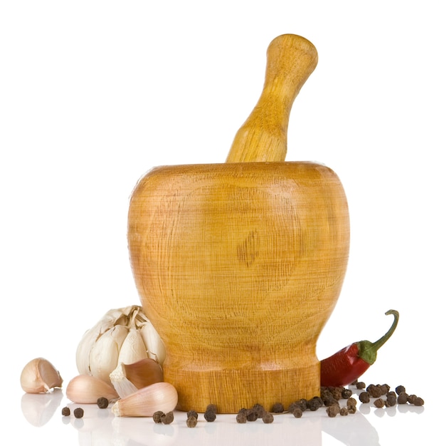 Garlic, pepper in mortar and pestle isolated 