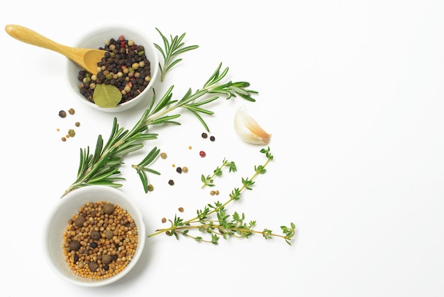 Garlic, rosemary, bay leaves, allspice and pepper isolated on white space. Flat lay. Top view