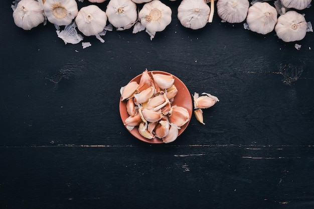 Garlic A set of fresh garlic on the chest wooden background Top view Copy space