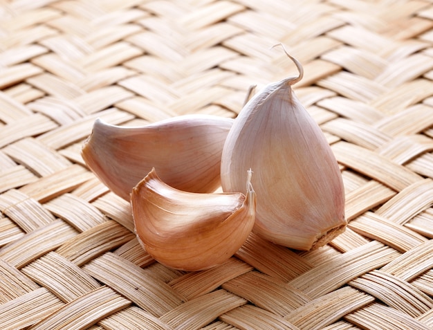 Garlic whole and cloves on the wooden background