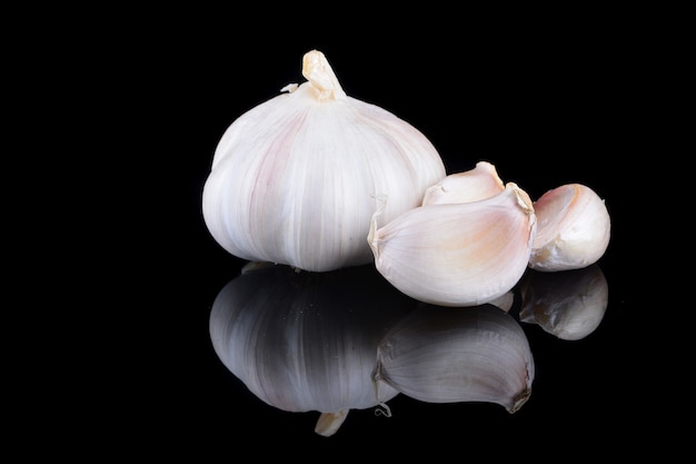 Garlic with reflection on black background