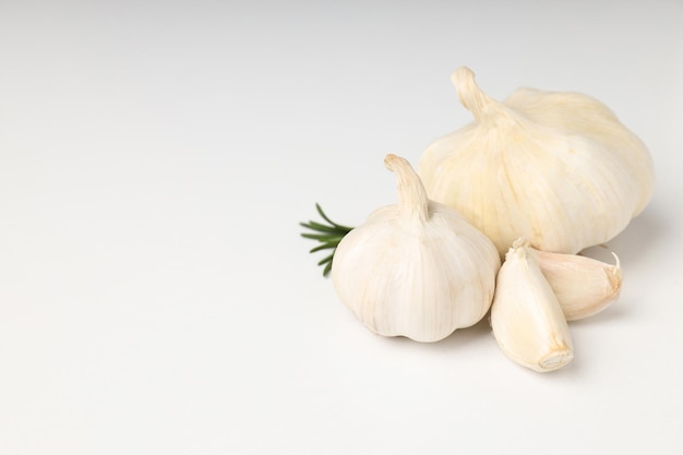 Garlic with rosemary on white background, space for text