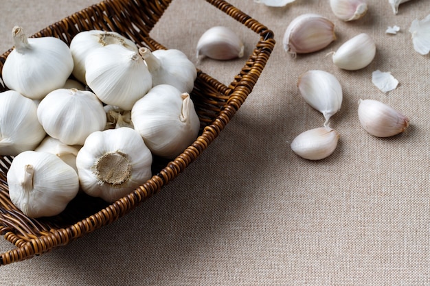 Garlic in a wooden bowl is ready to cook in the kitchen.