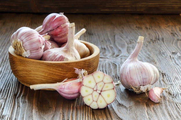 Garlic in a wooden bowl on the kitchen table